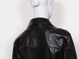 the back of a mannequin mannequin wearing a black leather jacket
