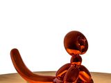 a glass sculpture of a cat sitting on a table