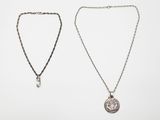 two silver necklaces on a white background
