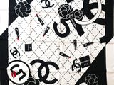 a black and white scarf with a picture of a chanel logo on it