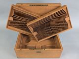 a wooden box with a bunch of wooden spoons inside of it