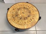 a wooden table with a circular design on top of it