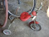 a tricycle with a red seat and a red seat on it