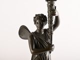 statue of a woman holding a torch in her right hand