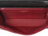 the inside of a black and white purse with a red lining