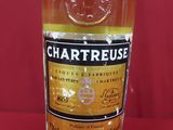 a close up of a bottle of liquor on a red surface