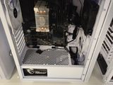 a white computer case sitting on top of a white desk