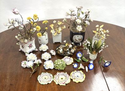 a table with a bunch of vases and flowers on it