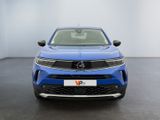 the front view of a blue suv parked in a showroom