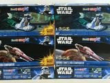 six star wars action figures sit in a row on a table