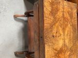 a small wooden table with a book on top of it