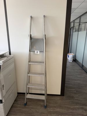 a ladder leaning against a wall in an office