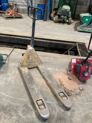 a fork lifter sitting on top of a table in a garage