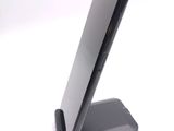 a cell phone on a stand on a white surface