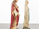 two statues of jesus and mary are standing next to each other