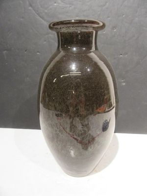 a brown vase sitting on a white table