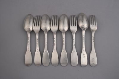 six forks and spoons are arranged in a row on a gray surface
