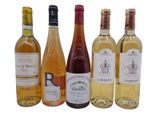 several bottles of wine are lined up on a white surface