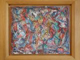 an abstract painting in a wooden frame on a wall