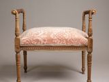 an upholstered bench with a floral upholstered cushion