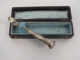 a silver spoon in a box on a table