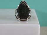 a close up of a ring with a black stone in it