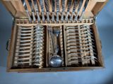 many forks and spoons in a wooden box