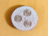a small coin sitting on top of a yellow surface