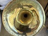 a large brass instrument that is sitting on the ground