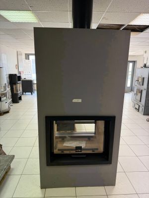 a fireplace in the middle of a room with a tile floor