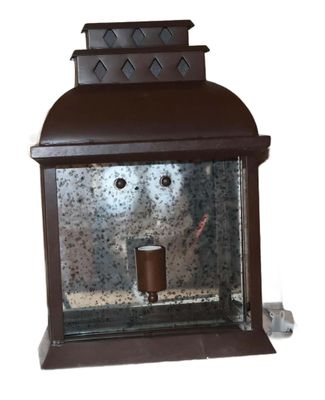 a brown lantern with a candle inside of it