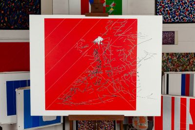 a picture of a red and white painting on a easel