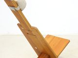 a wooden chair with a white blanket on top of it