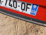 a close up of a license plate on a red car