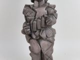 statue of a man with a hat and a jacket on a base