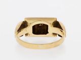 a close up of a gold ring with a brown stone in the center