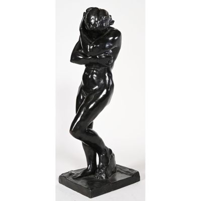 a black statue of a man with his arms crossed