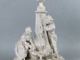 une statue représentant un homme et une femme assis sur un socle