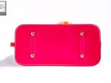 a close up of a pink purse on a white surface