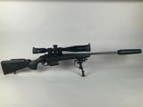 a rifle on a tripod with a scope on it