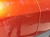 a close up of a car ' s door handle and the door handle of the car