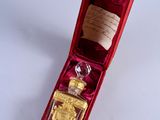 a bottle of perfume in a red box on a white surface