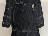 an image of a black dress on a mannequin stand