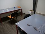 a room with a table, chairs, and a chair in it
