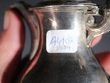 someone is holding a glass jar with a sticker on it