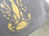 a close up of a hat with a hand print on it