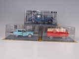 three toy cars that are sitting in a display case
