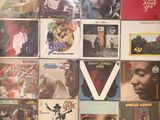 a lot of records on the wall of a room