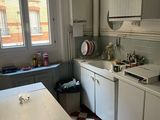 a kitchen with a checkered floor and white cabinets