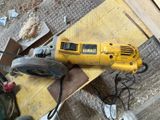 a corded sander sitting on a piece of wood